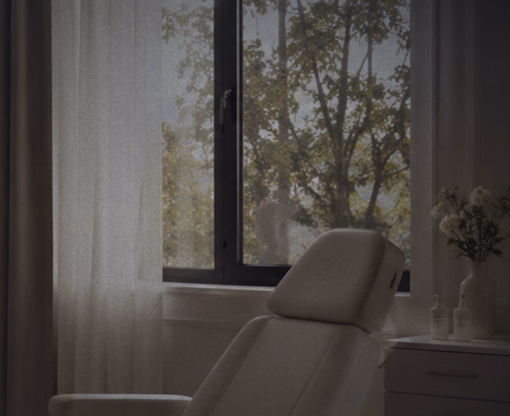 A consultation room at the clinic, with a treatment chair beside a curtained window